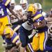 Ypsilanti running back Tyree Weatherspoon is stopped by Saline defenders on Friday. Daniel Brenner I AnnArbor.com